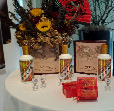 Kweichow Moutai bottles and glasses with display of sorghum. 